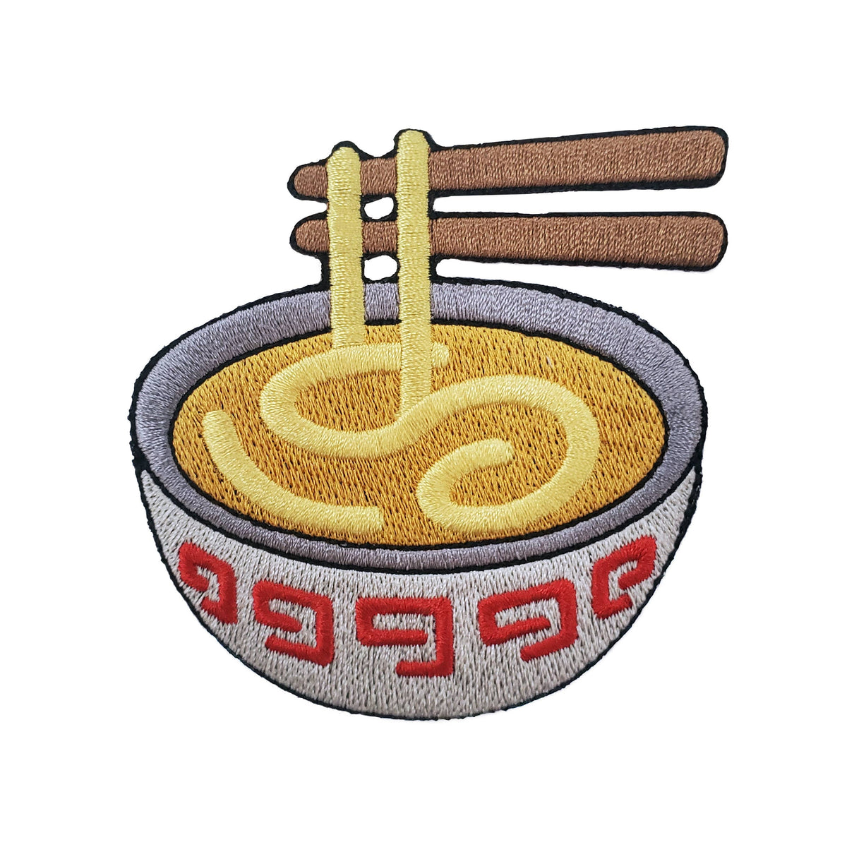 Embroidered patch of a bowl of ramen with chopsticks, featuring yellow noodles, brown chopsticks, a gray bowl rim, and red geometric patterns on a white bowl, isolated on a white background.