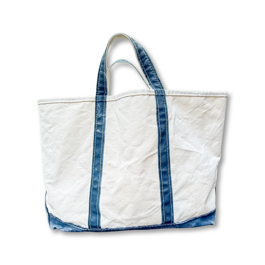 White tote bag with blue denim accents on a white background
