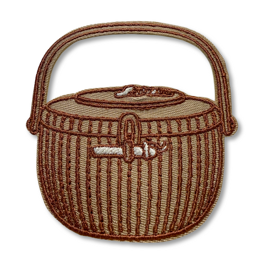 Brown woven Nantucket basket with handle on a white background