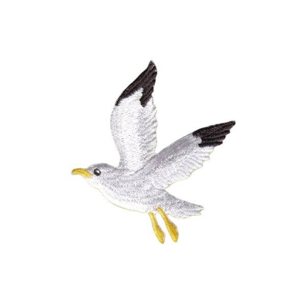 Toy seagull with open wings on a white background