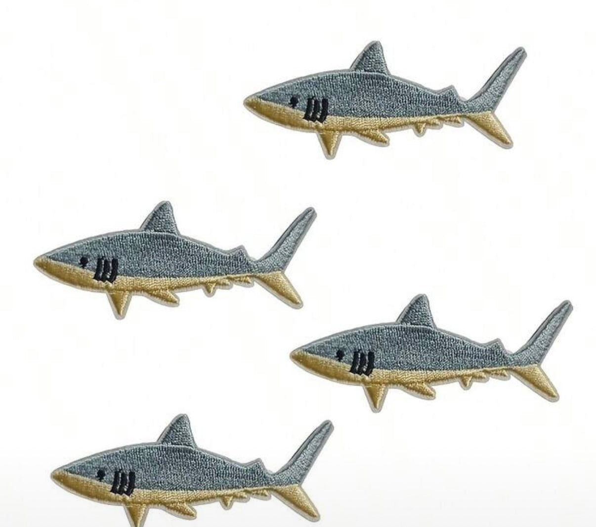 Five shark-shaped patches on a white background