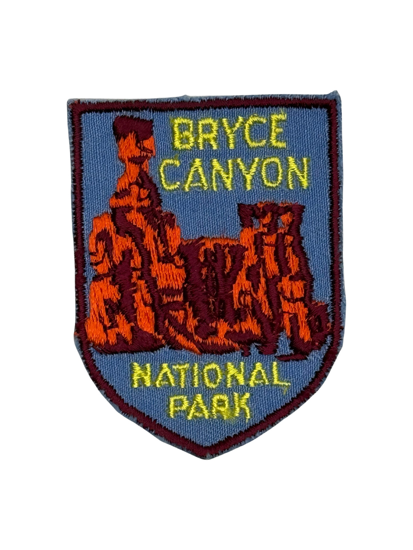 Embroidered patch of Bryce Canyon National Park with red rock formations on a blue background