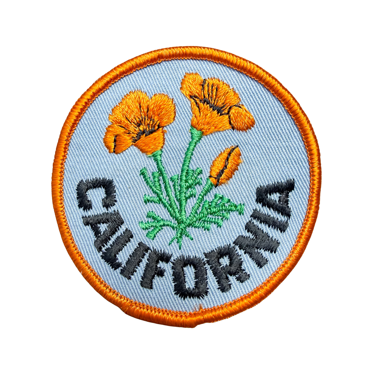 Circular patch with orange flowers and 'California' text on a light blue background