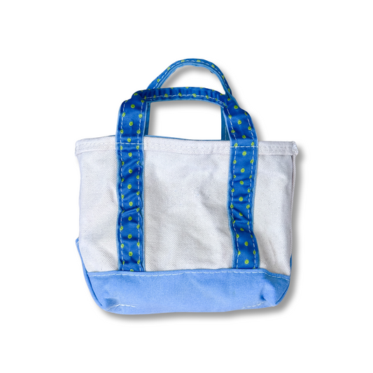 White tote bag with blue handles and trim on a white background