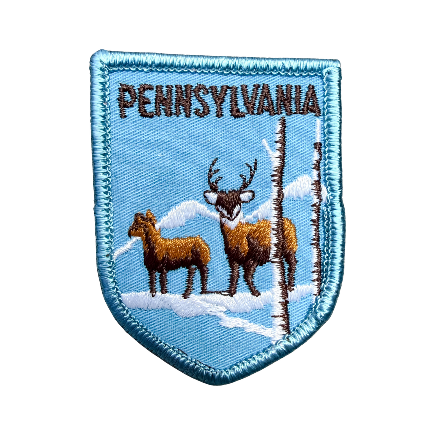 Embroidered patch with 'Pennsylvania' text and deer design on a blue background