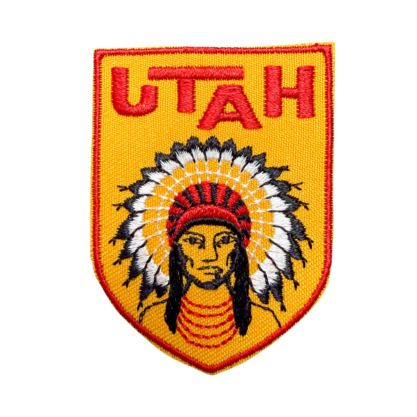 Emblem with 'UTAH' text and Native American headdress design on a yellow background
