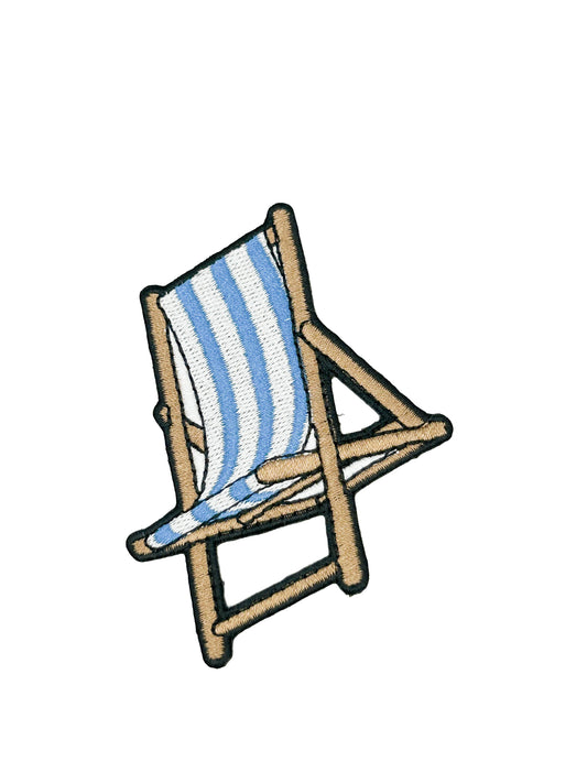 Embroidered patch of a blue and white striped beach chair on a white background