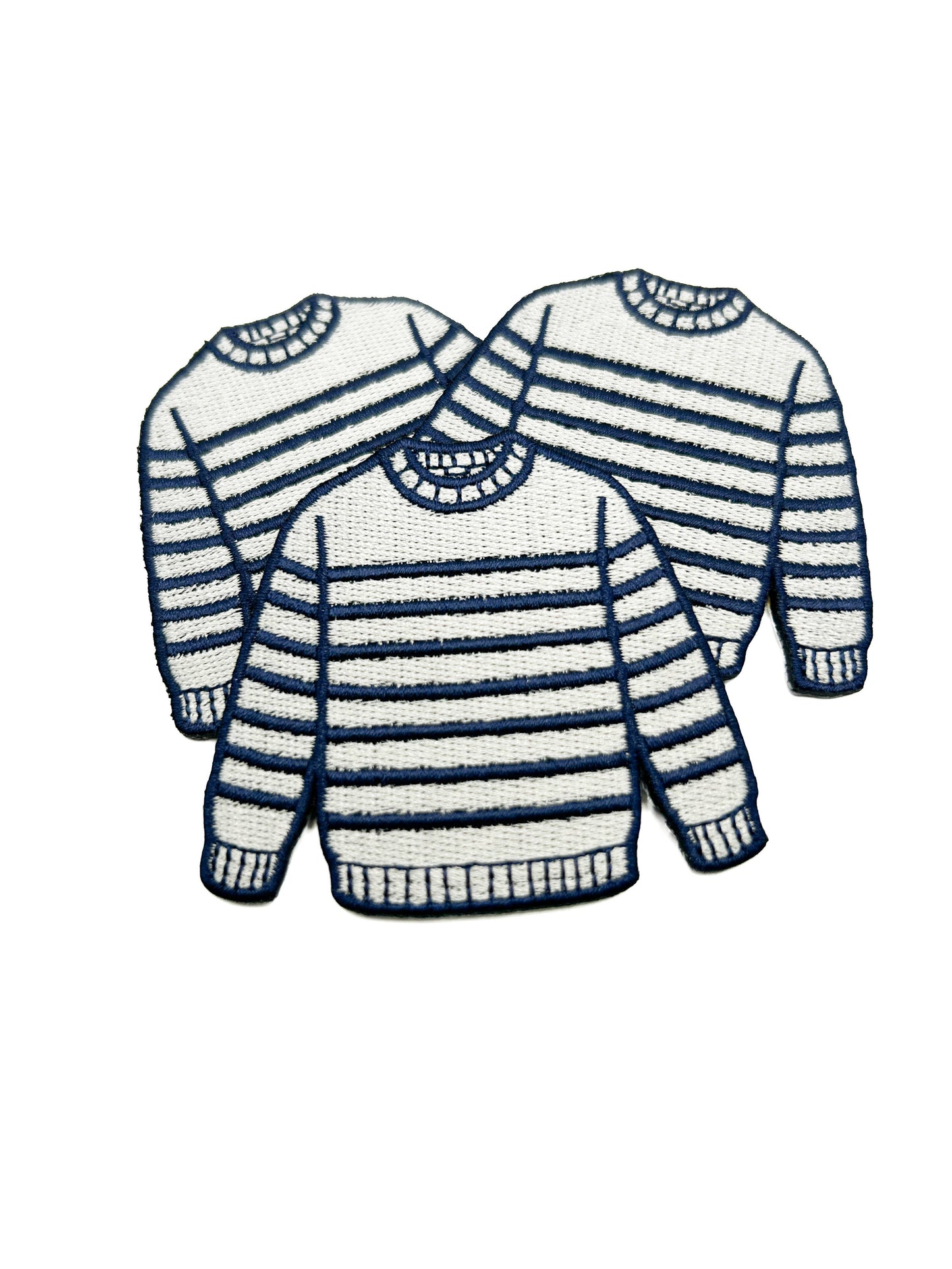 Three striped sweaters in navy and white on a white background