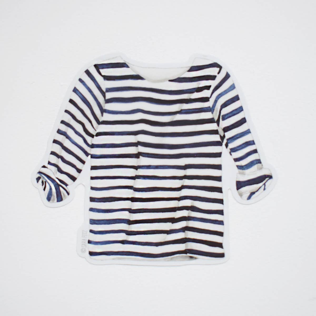 A long-sleeve striped top with horizontal navy, black, and white stripes, laid flat against a light gray background.