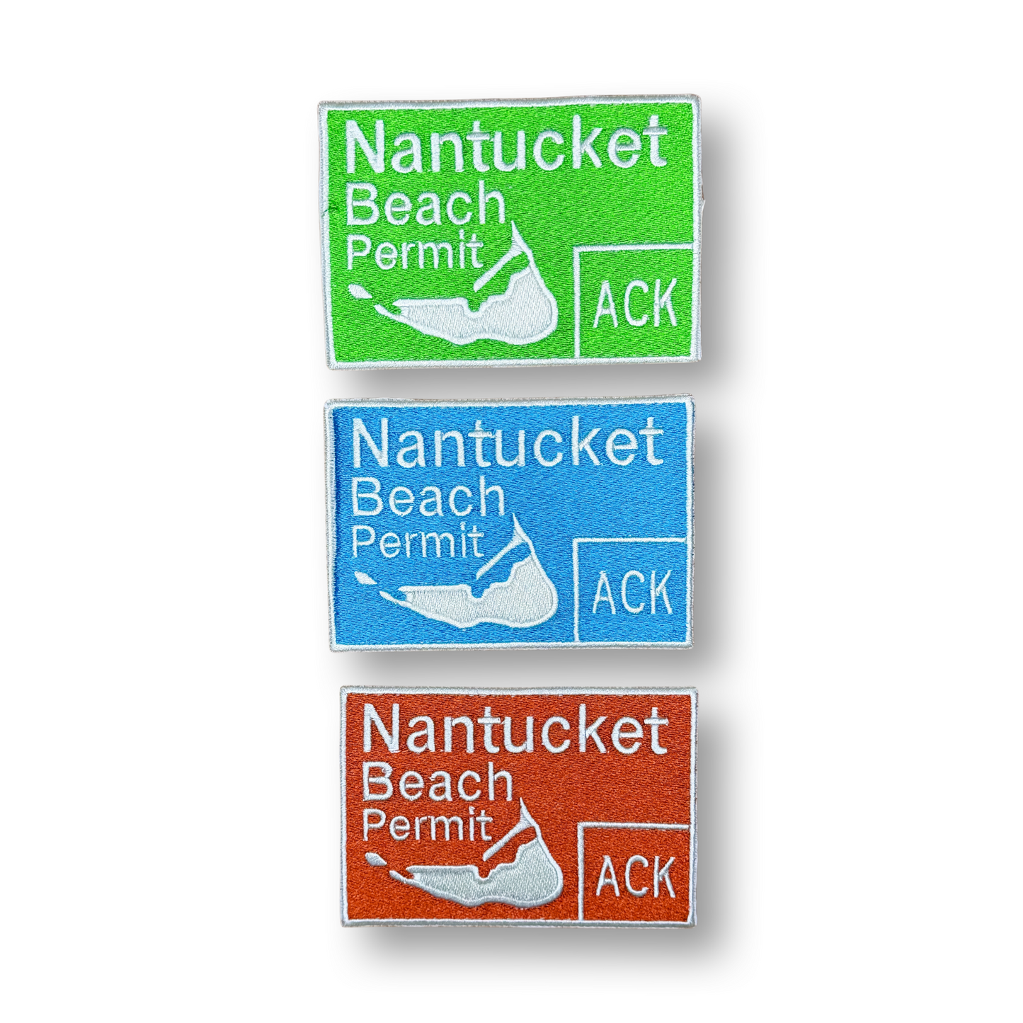 Three Nantucket Beach Permit signs in green, blue, and orange on a white background.