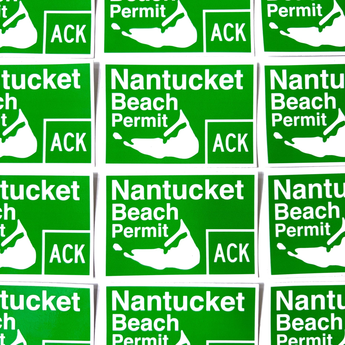 A grid of identical green rectangular stickers reading 'Nantucket Beach Permit' with a white map outline and 'ACK' in a box, shown on a white background.