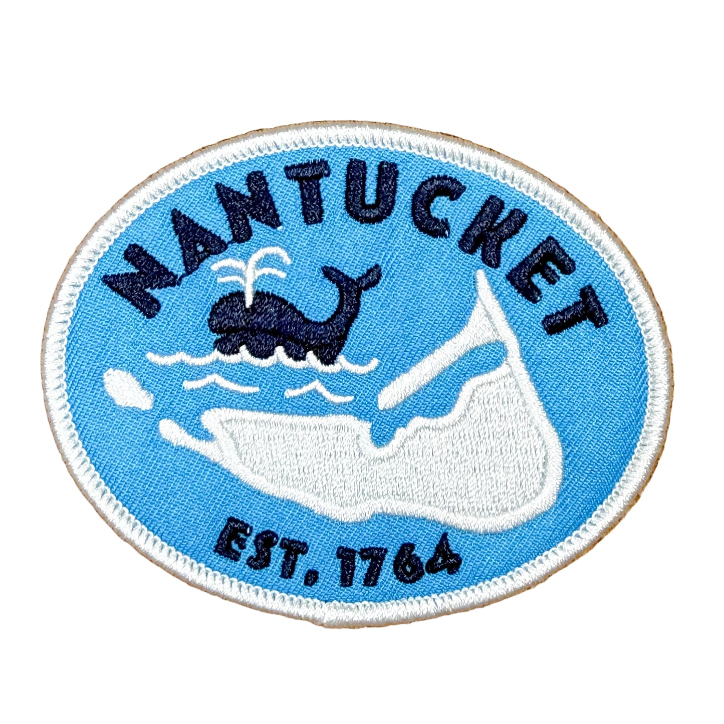 Nantucket patch with whale and sailboat design on a brown background