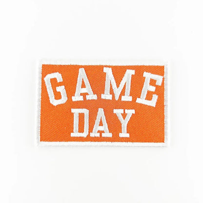 Embroidered patch with 'GAME DAY' text on an orange background