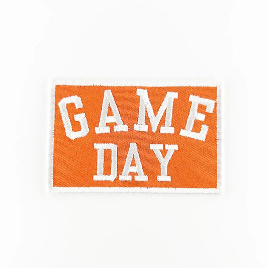 Embroidered patch with 'GAME DAY' text on an orange background