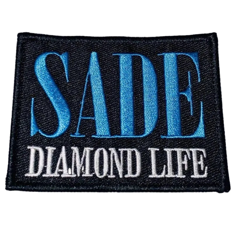 Embroidered patch with 'SADE DIAMOND LIFE' text on a textured fabric background