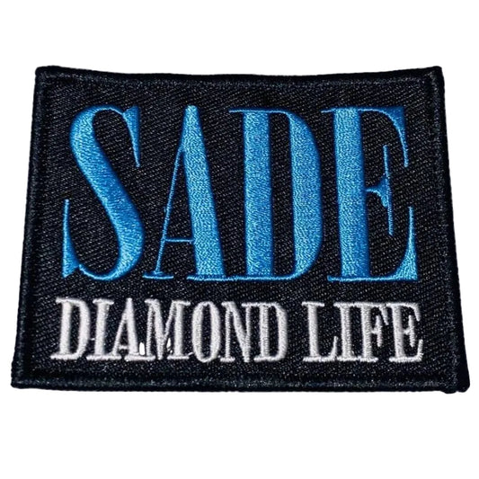 Embroidered patch with 'SADE DIAMOND LIFE' text on a textured fabric background