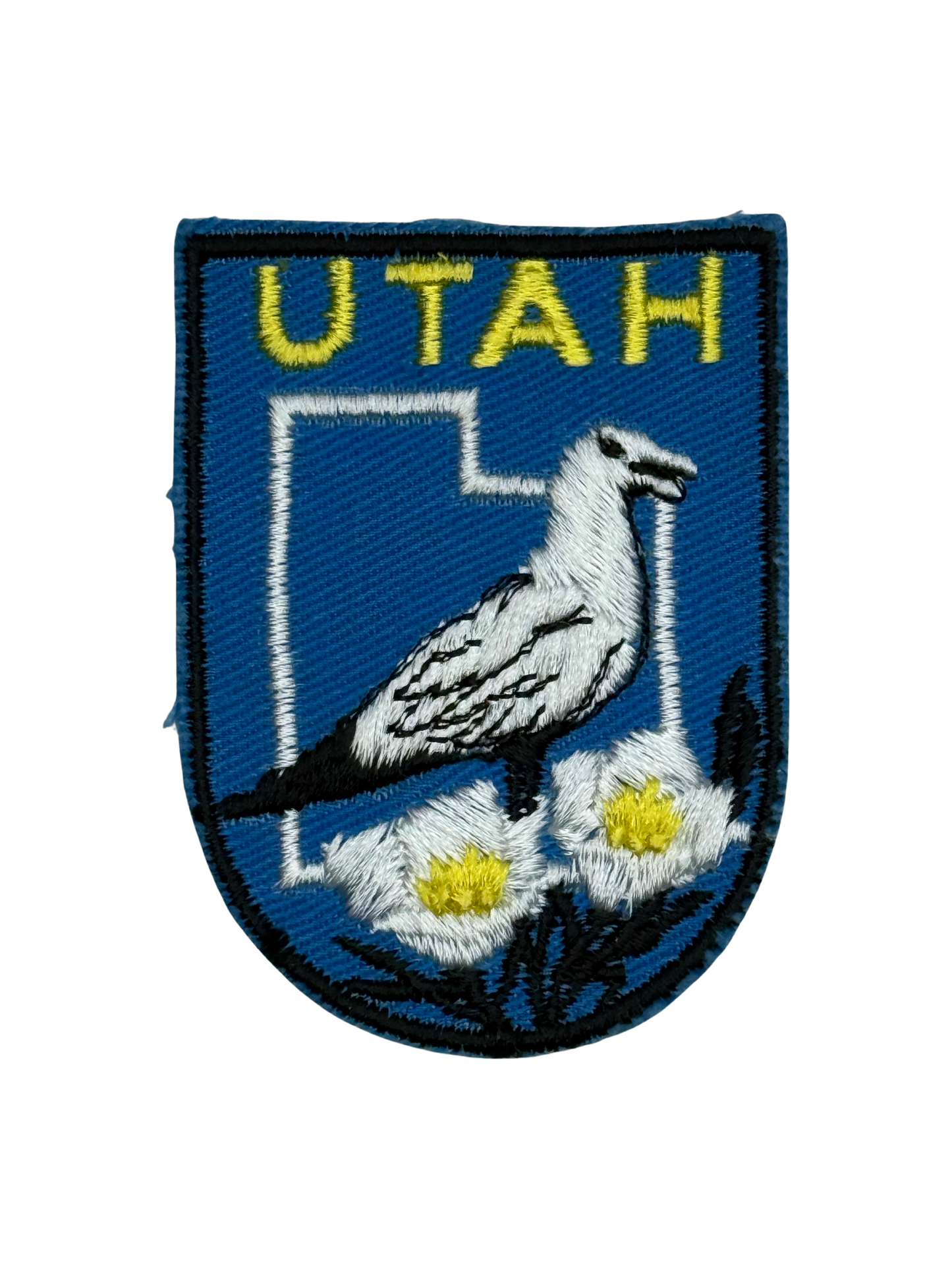 Embroidered patch with 'UTAH' text, a bird, and flowers on a blue background