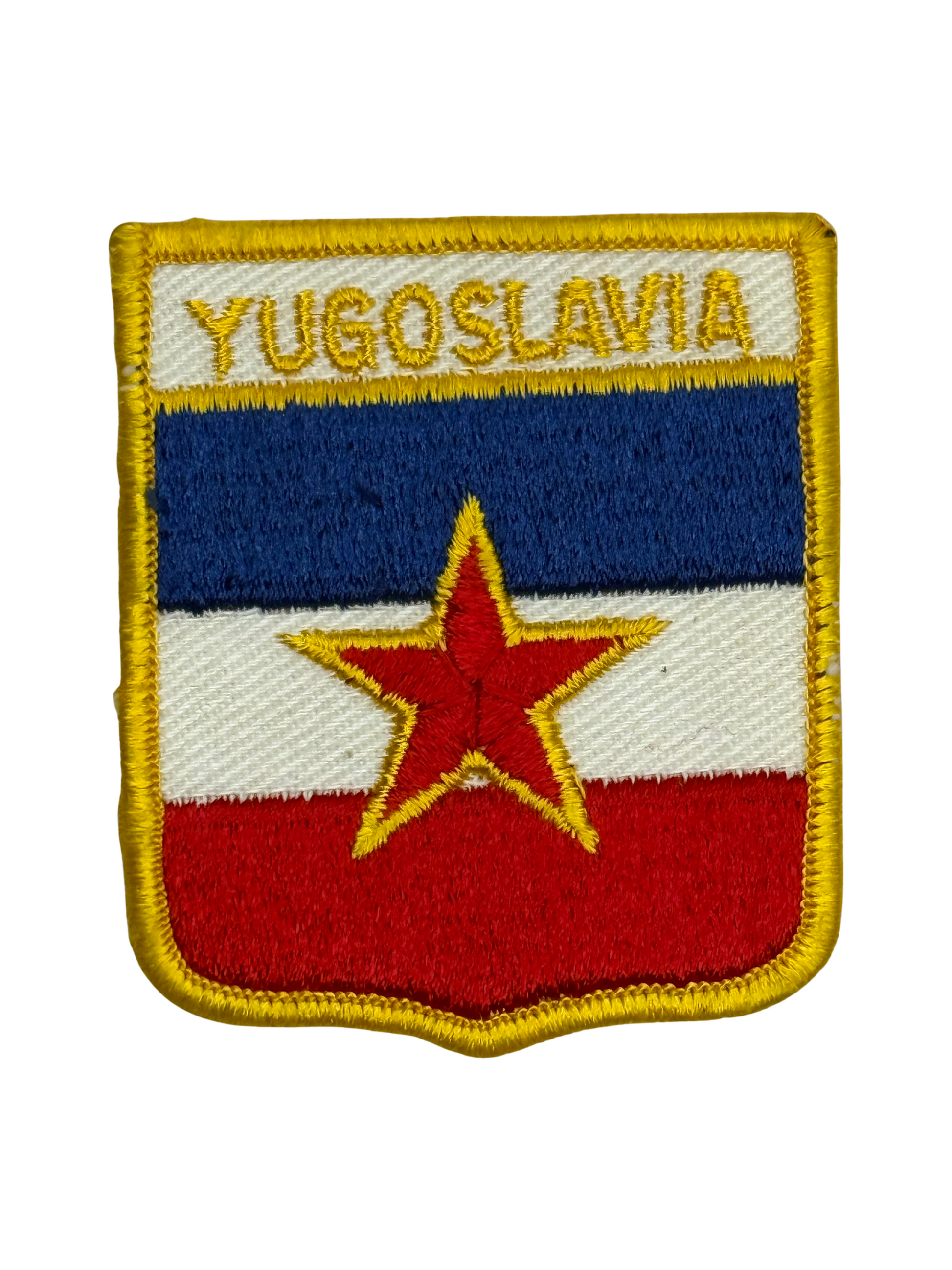Patch with the flag of Yugoslavia featuring a red star on a blue and red background.