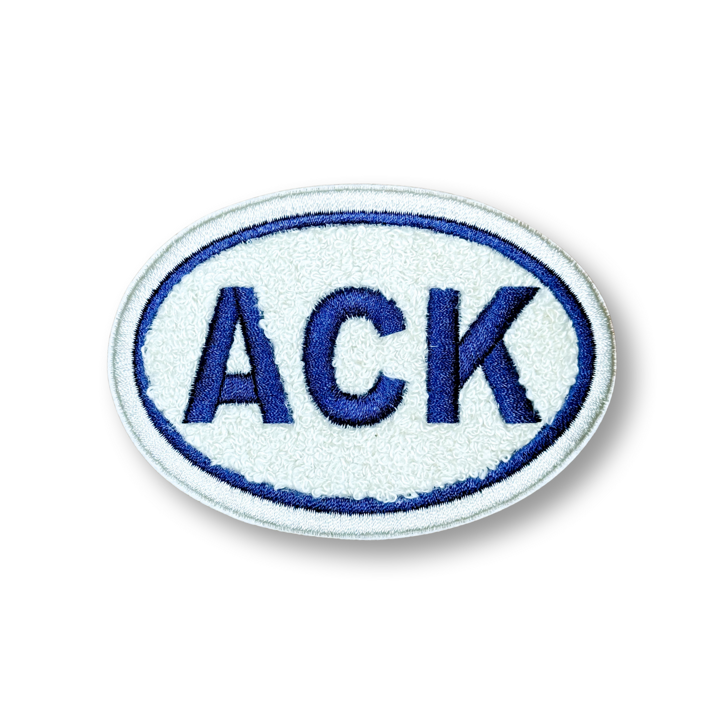 Oval patch with 'ACK' in blue on a white background