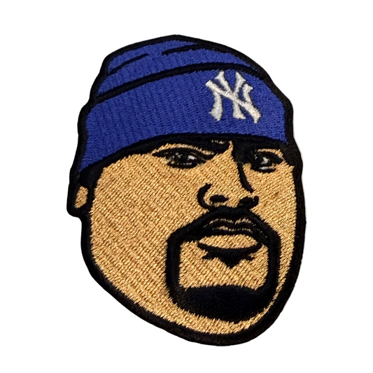 Embroidered patch of a person wearing a blue beanie with a logo, on a beige background.