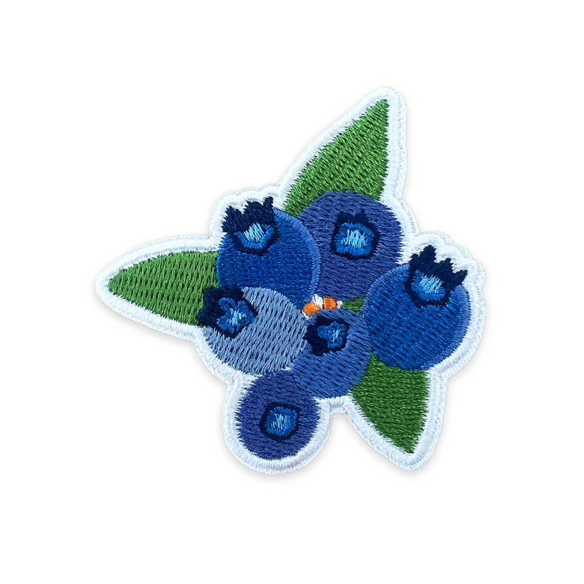 An embroidered patch featuring blueberries and green leaves on a white background.