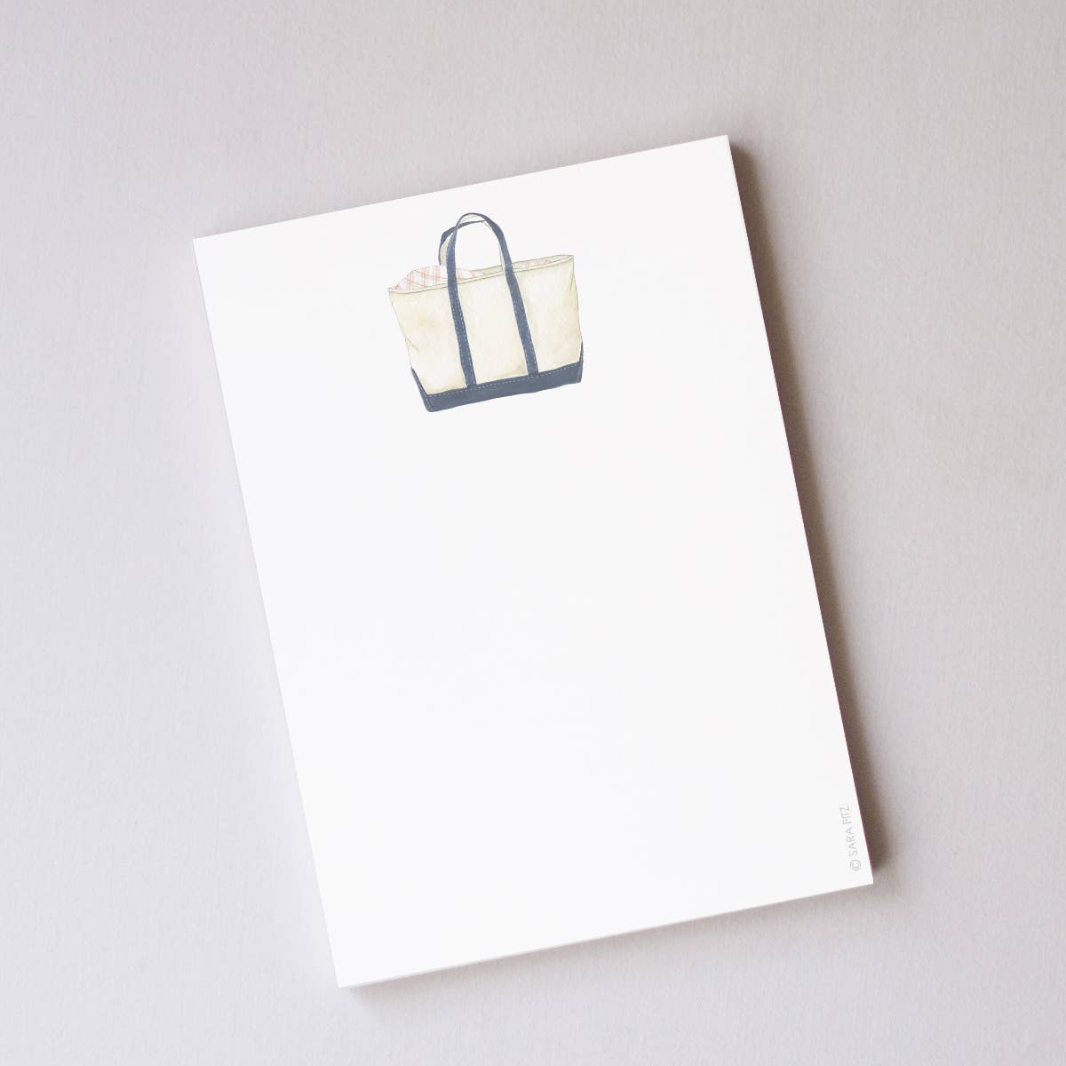 White tote bag with blue accents on a white background