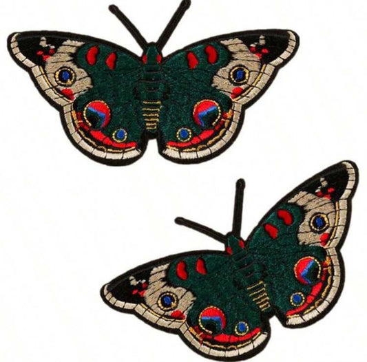 Two butterfly patches with colorful patterns on a white background