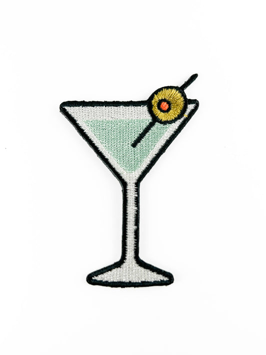 Patch of a martini glass with a olive on a white background