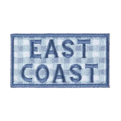 Patch with 'East Coast' text on a checkered pattern against a beige background