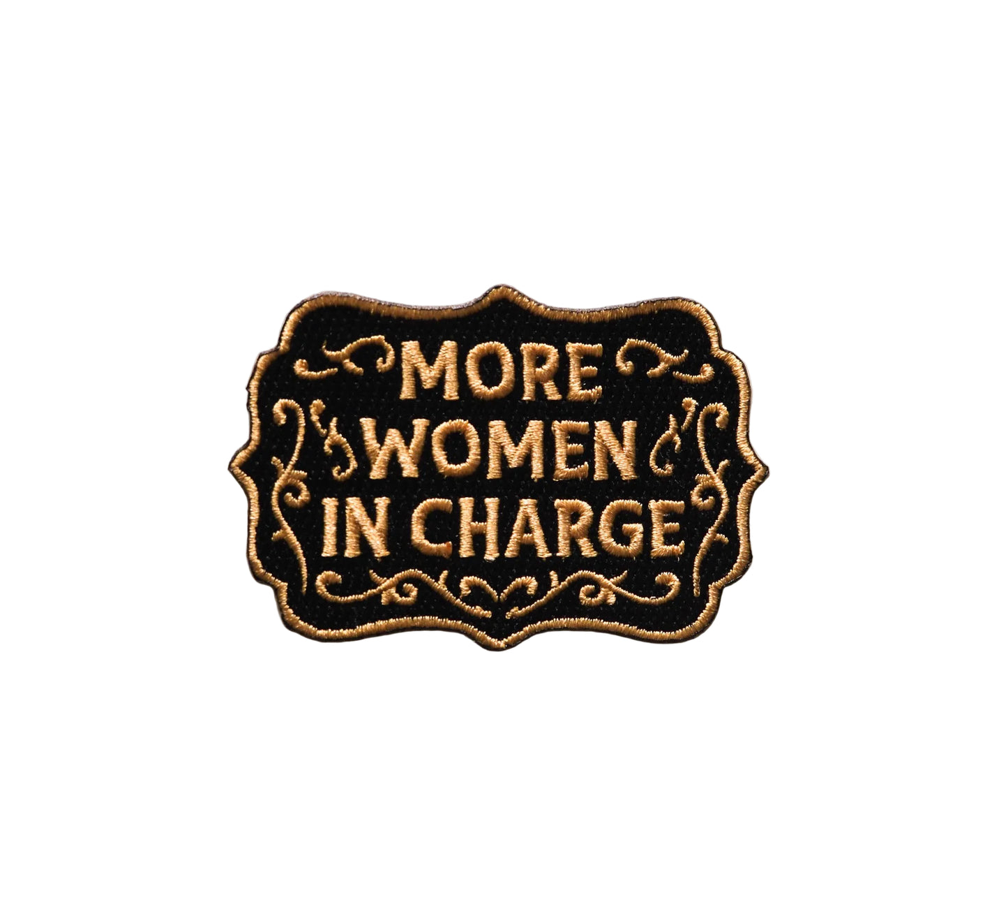 Patch with 'More Women in Charge' text on a white background