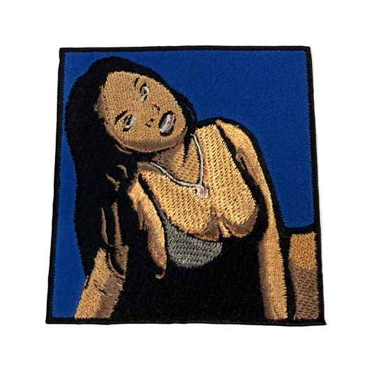 Embroidered patch of Foxy Brown with a blue background