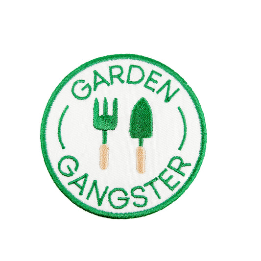 Circular patch with 'Garden Gangster' text and gardening tools on a white background