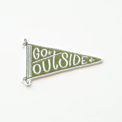 Green and white pennant patch with 'Go Outside' text on a white background