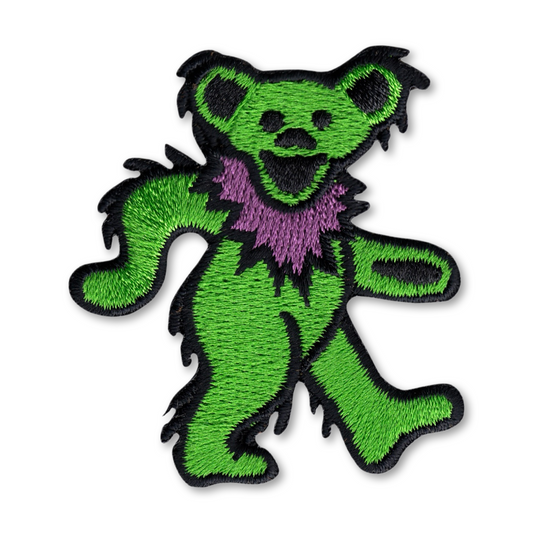 An embroidered patch of the Grateful Dead dancing bear, featuring a bright green body with a purple neck collar and black embroidered outlines on a white background.