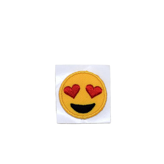 Emoticon patch with heart eyes on a beige fabric background