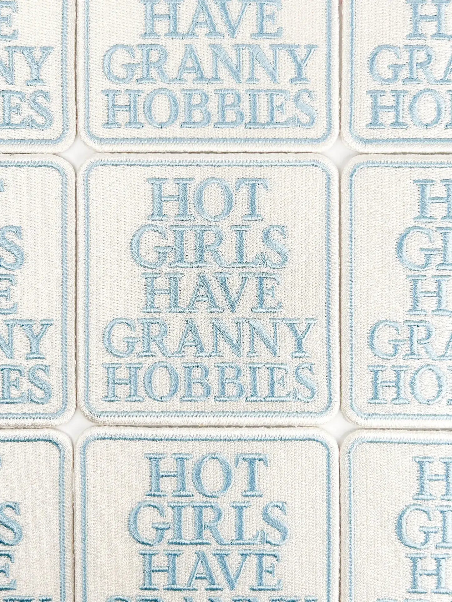 Text pattern with phrases like 'Have Granny Hobbies' and 'Hot Girls Have Granny Hobbies' on a tiled background.