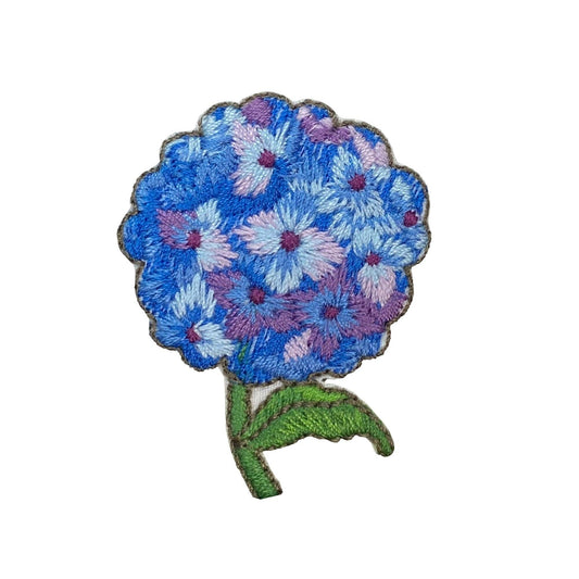 Floral patch with blue and pink flowers on a white background