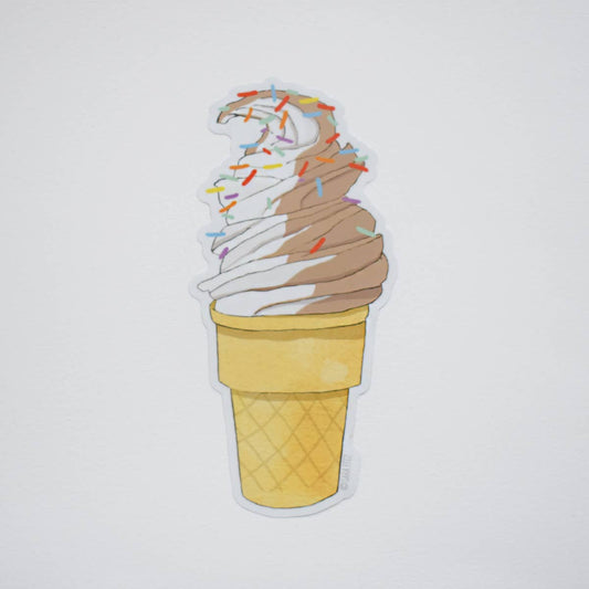 Ice cream cone with colorful sprinkles on a light gray background