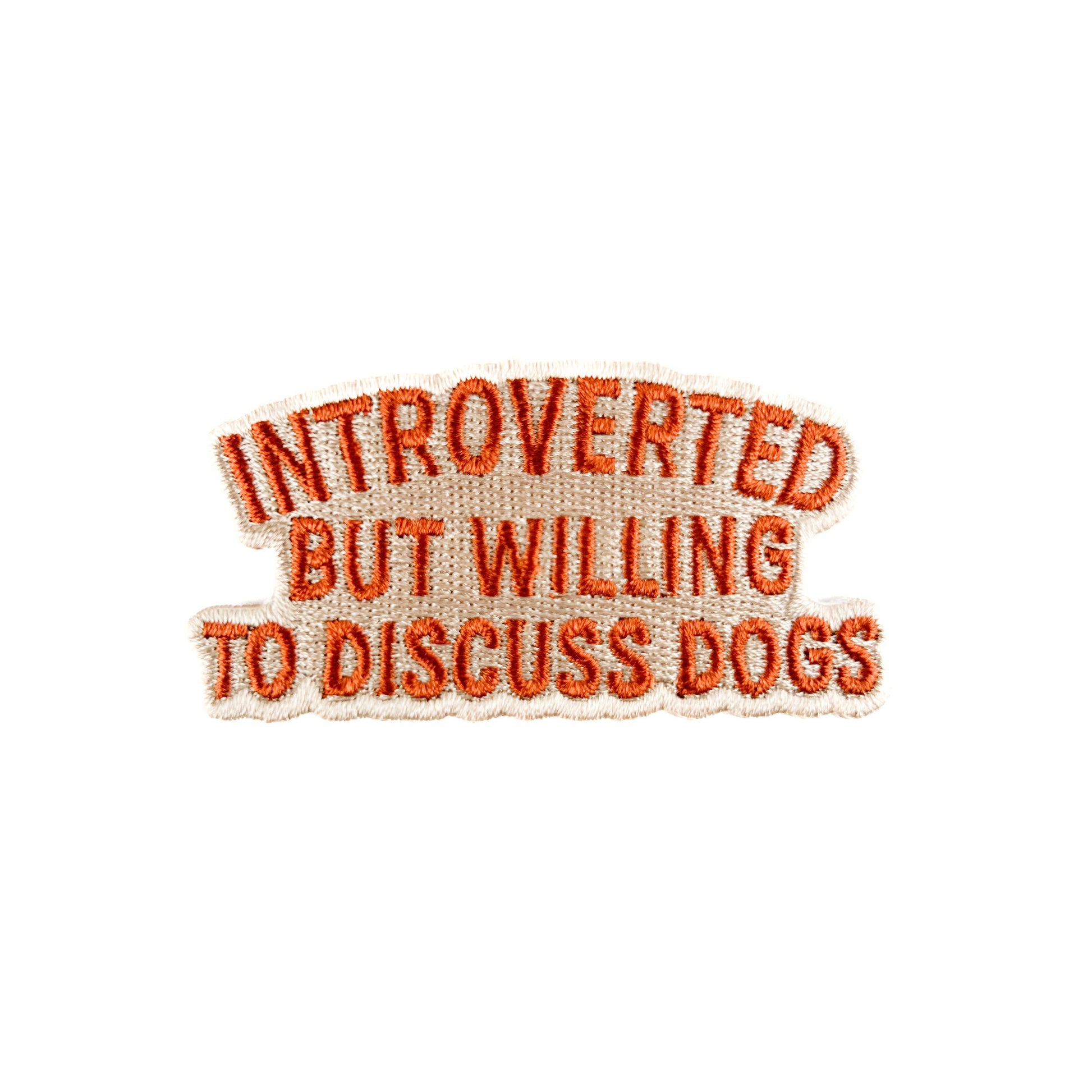 Embroidered patch with text 'Introverted but willing to discuss dogs' on a white background
