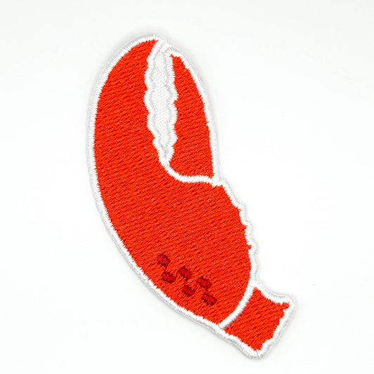 An embroidered lobster claw patch in bright red-orange with a white border, shown on a plain white background.