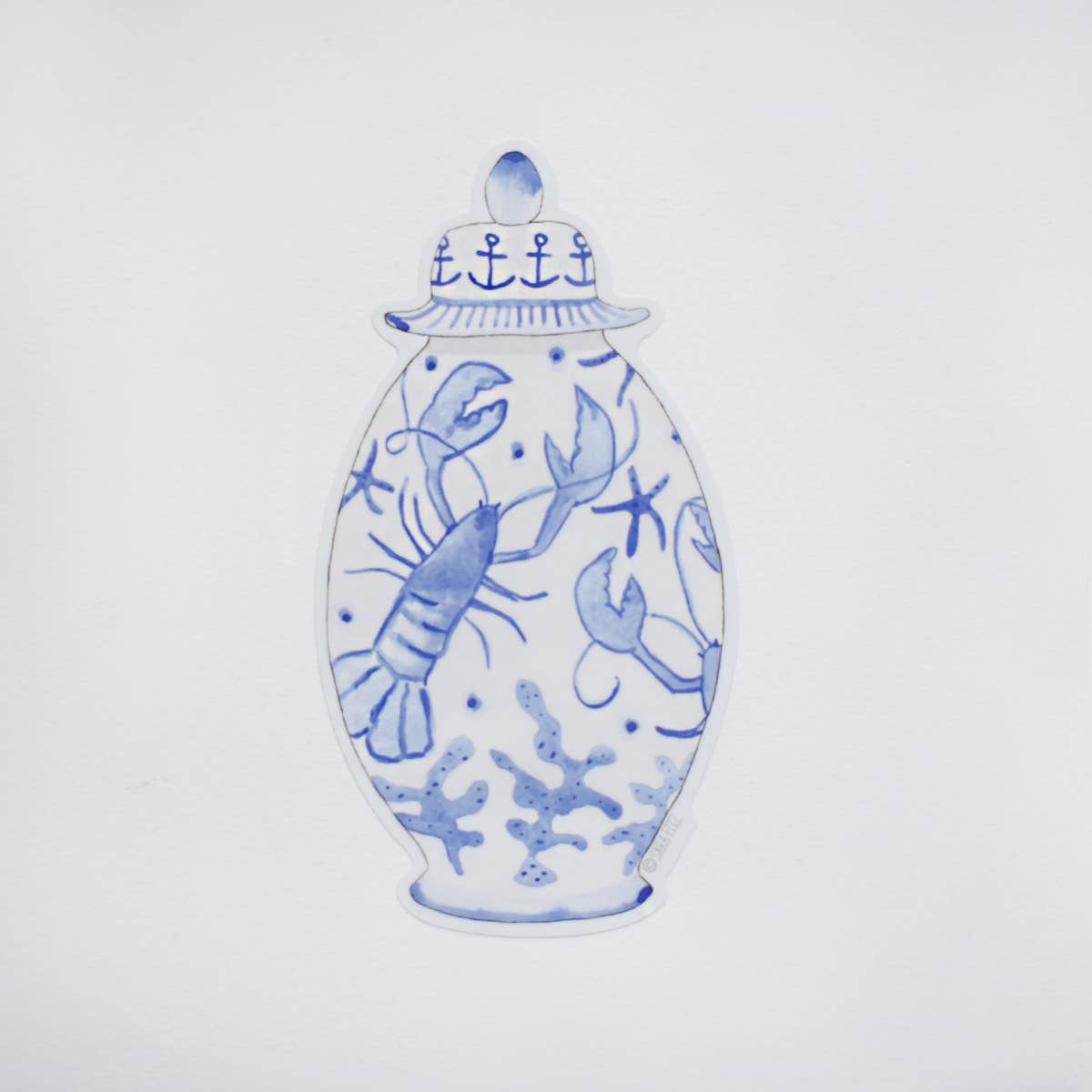 A blue and white ceramic ginger jar with a lid, decorated with illustrations of a lobster, starfish, and coral, shown on a plain white background.