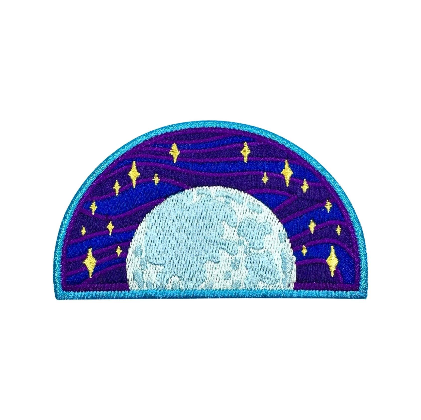 An embroidered patch depicting a celestial night sky with a large light blue moon and yellow stars against a purple and blue starry background, finished with a turquoise border.