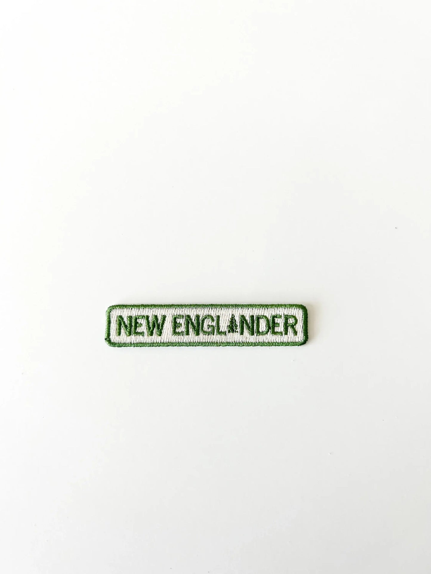Text patch with 'NEW ENGLANDER' on a white background