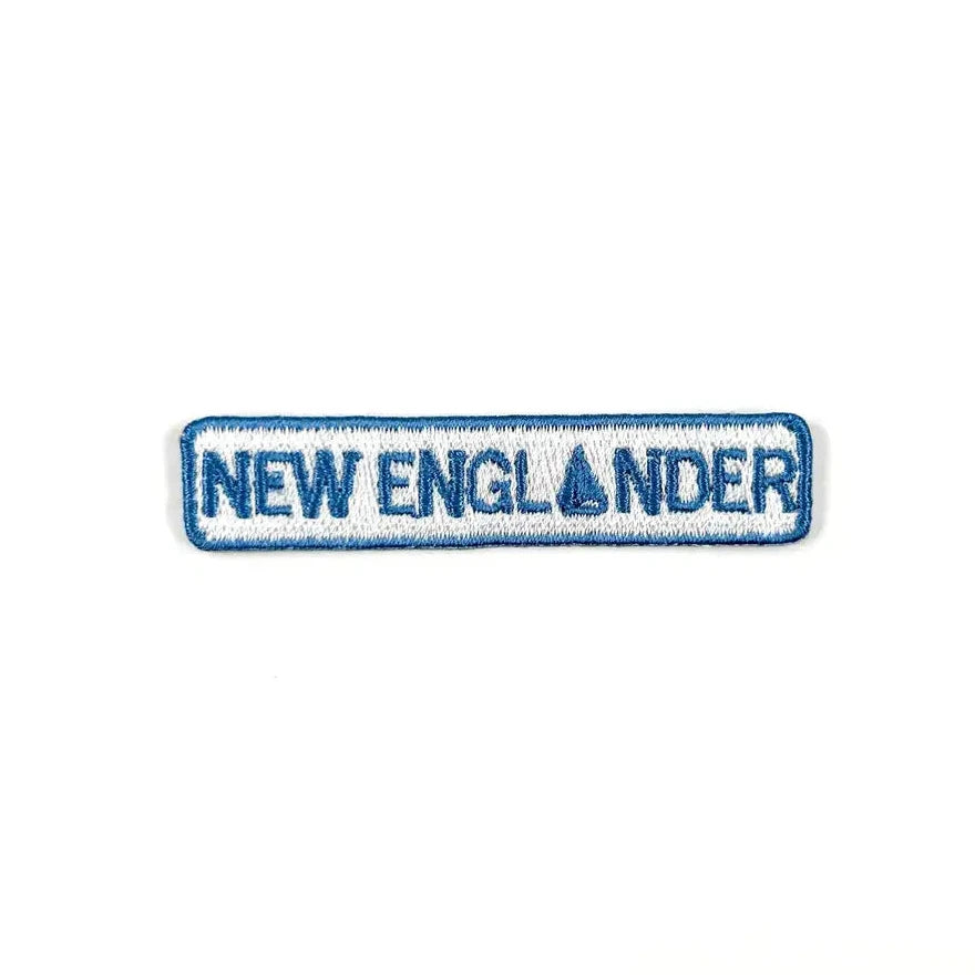 Embroidered patch with 'NEW ENGLANDER' text on a white background