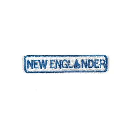 Embroidered patch with 'NEW ENGLANDER' text on a white background