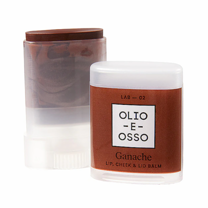 Champagne Hippie Olio E Osso lip balm shown in a clear jar with a white lid and a brown label, alongside a translucent stick container with a brown cap, on a white background.