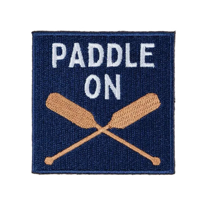 Patch with 'Paddle On' text and crossed oars on a navy background