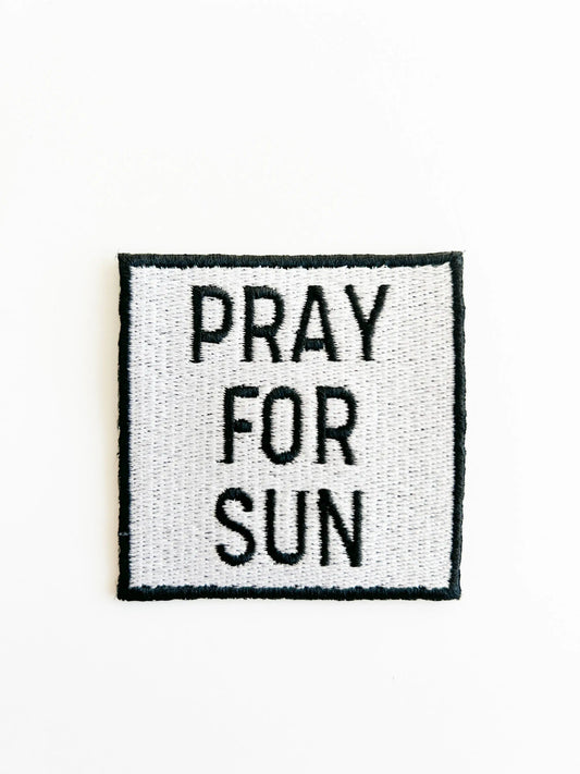 Square patch with 'PRAY FOR SUN' text on a white background