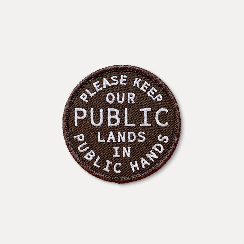Round brown patch with white text on a light gray background