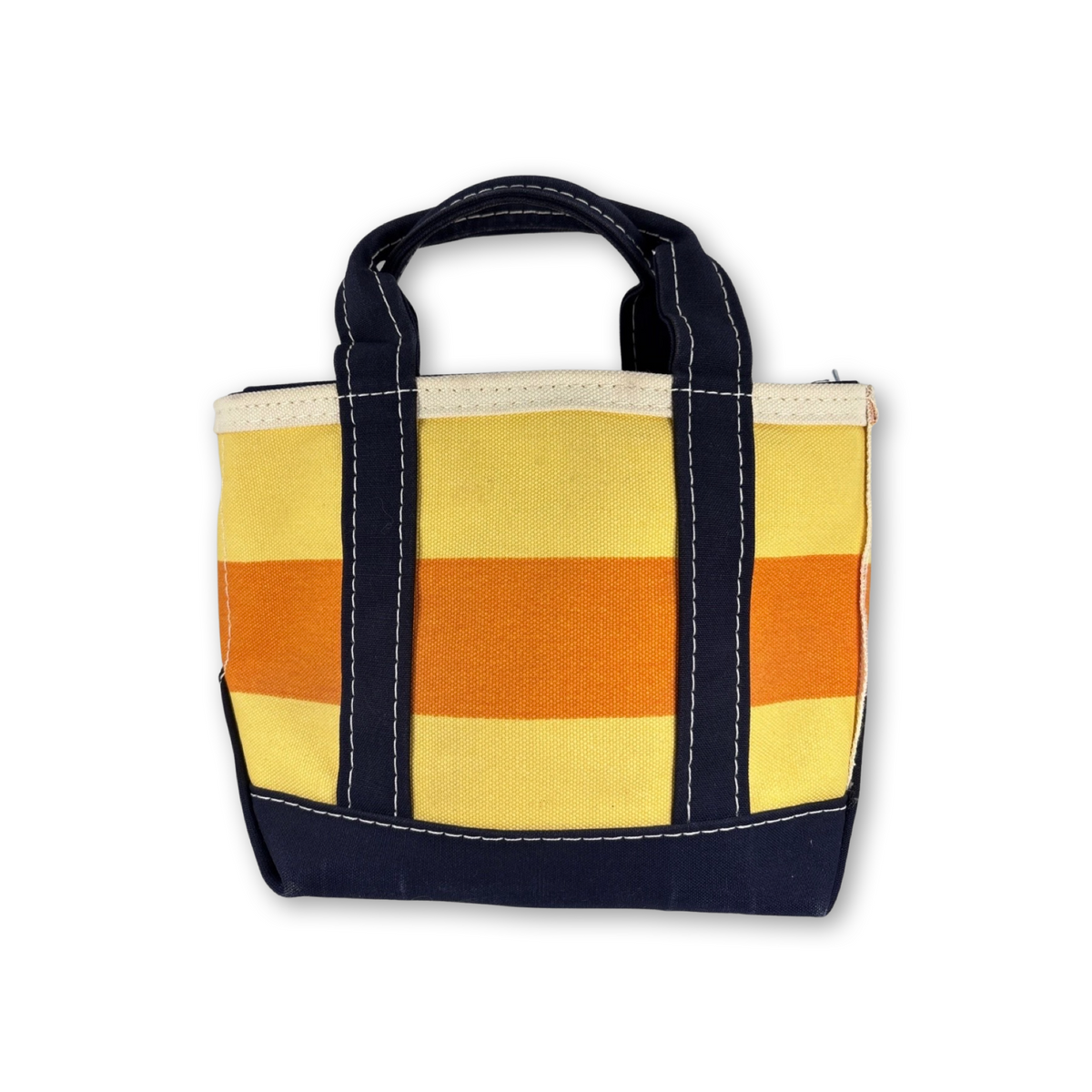 A small canvas tote bag with horizontal stripes in yellow, orange, and cream, featuring dark navy blue handles and trim with white contrast stitching, shown on a plain white background.